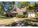 Charming brick home with well-manicured landscaping and a pathway leading to the front door at 2896 Toney Dr, Decatur, GA 30032