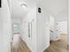 Bright hallway featuring hardwood flooring, crisp white walls and multiple doors at 2896 Toney Dr, Decatur, GA 30032