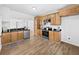 Modern kitchen with stainless steel appliances, wood cabinets, granite countertops, and new floors at 2896 Toney Dr, Decatur, GA 30032
