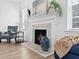 Bright living room with a beautiful fireplace, wood floors and natural light from large windows at 2896 Toney Dr, Decatur, GA 30032