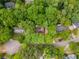 Aerial view of a home surrounded by mature trees with neighborhood, and a cul-de-sac street at 335 Cameron Ridge Dr, Atlanta, GA 30328