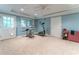 Carpeted basement gym with ceiling fan, exercise equipment, and natural light at 335 Cameron Ridge Dr, Atlanta, GA 30328