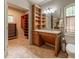 Elegant bathroom with vanity, ample built-in shelving, and a view into an adjacent walk-in closet at 335 Cameron Ridge Dr, Atlanta, GA 30328