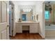 Bright bathroom with wood floors, a large mirror, and dual vanity at 335 Cameron Ridge Dr, Atlanta, GA 30328