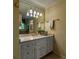 Bathroom featuring a large mirror and a vanity with double sinks and gold hardware at 335 Cameron Ridge Dr, Atlanta, GA 30328