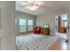 Comfortable bedroom featuring three windows, a ceiling fan, and a charming red chair at 335 Cameron Ridge Dr, Atlanta, GA 30328