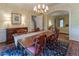 Formal dining room showcasing a chandelier, large window, and access to the living room, perfect for entertaining guests at 335 Cameron Ridge Dr, Atlanta, GA 30328