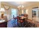 Elegant dining room featuring a chandelier, patterned wallpaper, and large window, ideal for hosting gatherings at 335 Cameron Ridge Dr, Atlanta, GA 30328