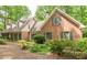Charming brick home featuring green shutters and a well-manicured lawn, creating a warm and inviting curb appeal at 335 Cameron Ridge Dr, Atlanta, GA 30328