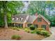 Traditional brick home with lush greenery and manicured landscaping, offering a serene and picturesque setting at 335 Cameron Ridge Dr, Atlanta, GA 30328