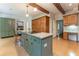 Open kitchen featuring a gray center island, custom wooden cabinets, and stainless appliances at 335 Cameron Ridge Dr, Atlanta, GA 30328