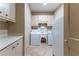Functional laundry room featuring a washer, dryer, sink, and ample storage cabinets at 335 Cameron Ridge Dr, Atlanta, GA 30328