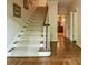 Elegant staircase with carpeted steps and hardwood flooring, leading to the upper level of this beautiful home at 335 Cameron Ridge Dr, Atlanta, GA 30328