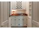Convenient wet bar with white cabinets, wine rack, and sink at 335 Cameron Ridge Dr, Atlanta, GA 30328
