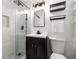 Updated bathroom featuring a glass shower, modern vanity, and decorative lighting at 3890 Cherrydale Se Ln, Smyrna, GA 30082