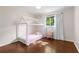 Cozy bedroom with wood floors, a window with curtains, and a decorative canopy bed at 3890 Cherrydale Se Ln, Smyrna, GA 30082