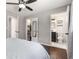 Well-lit bedroom featuring hardwood floors, a ceiling fan, and an ensuite bathroom at 3890 Cherrydale Se Ln, Smyrna, GA 30082