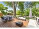 Outdoor deck area with dining set, lounge furniture, and lush green surroundings at 3890 Cherrydale Se Ln, Smyrna, GA 30082