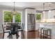 Open concept kitchen with stainless steel appliances, white cabinets, and hardwood flooring at 3890 Cherrydale Se Ln, Smyrna, GA 30082