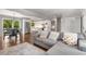 Spacious living room with gray sofa, hardwood floors, and view into kitchen and dining area at 3890 Cherrydale Se Ln, Smyrna, GA 30082