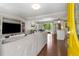 Open concept living room with hardwood floors leading into dining area and kitchen at 3890 Cherrydale Se Ln, Smyrna, GA 30082