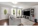 Cozy living room featuring a gray sofa, large built-in shelving, and hardwood floors at 3890 Cherrydale Se Ln, Smyrna, GA 30082