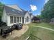 Back exterior of home with patio seating and a manicured lawn providing ideal relaxation and entertainment spaces at 4503 Woodhaven Ne, Marietta, GA 30067