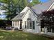 Back exterior of home with patio seating and a manicured lawn providing ideal relaxation and entertainment spaces at 4503 Woodhaven Ne, Marietta, GA 30067