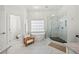 Bright bathroom features a soaking tub, glass shower, and marble floors for a luxurious spa experience at 4503 Woodhaven Ne, Marietta, GA 30067