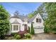 Charming two-story home featuring a landscaped yard, attached garage, and elegant architectural details at 4503 Woodhaven Ne, Marietta, GA 30067