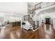 Spacious foyer features staircase access, view of kitchen, hardwood floors and access to front door at 4503 Woodhaven Ne, Marietta, GA 30067