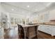 Gourmet kitchen featuring an island with seating, granite countertops, custom cabinets, and stainless appliances at 4503 Woodhaven Ne, Marietta, GA 30067