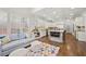 Spacious living area with modern kitchen, an island with seating, hardwood floors, and bright, natural light at 4503 Woodhaven Ne, Marietta, GA 30067