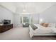 Relaxing main bedroom features neutral decor, a sitting area, plantation shutters, and bright, natural light at 4503 Woodhaven Ne, Marietta, GA 30067