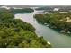 Stunning aerial view of the lakefront property surrounded by lush greenery and waterfront docks at 5560 Pilgrim Point Ext, Cumming, GA 30041