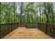 Spacious wooden deck surrounded by a leafy green forest at 5560 Pilgrim Point Ext, Cumming, GA 30041