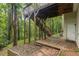 Exterior of home featuring a wooden deck, stairs, and wooded backyard at 5560 Pilgrim Point Ext, Cumming, GA 30041