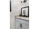 Elegant half-bathroom with a marble-look countertop and a framed mirror above the sink and white cabinets at 5560 Pilgrim Point Ext, Cumming, GA 30041