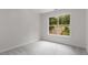 Bedroom with neutral carpet and a view of the landscaped front yard at 5560 Pilgrim Point Ext, Cumming, GA 30041