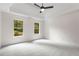 Spacious bedroom with neutral carpet, tray ceiling, and natural light at 5560 Pilgrim Point Ext, Cumming, GA 30041