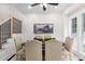Elegant dining room featuring neutral-toned chairs, a wooden table, and natural light from the large window at 5560 Pilgrim Point Ext, Cumming, GA 30041