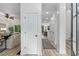 Bright entryway with white walls, wood floors, and a view into the living room and dining area at 5560 Pilgrim Point Ext, Cumming, GA 30041