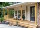 Inviting front porch featuring rocking chairs, wood floors, and natural wood columns, perfect for relaxing at 5560 Pilgrim Point Ext, Cumming, GA 30041