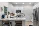 Modern kitchen featuring white cabinets, stainless steel appliances, quartz countertops, and a black sink at 5560 Pilgrim Point Ext, Cumming, GA 30041