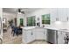 Open concept kitchen with stainless steel appliances, light countertops, and a view of the backyard through large windows at 5560 Pilgrim Point Ext, Cumming, GA 30041