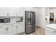 Kitchen showcasing stainless steel refrigerator, white cabinets, and light countertops for a modern, clean look at 5560 Pilgrim Point Ext, Cumming, GA 30041