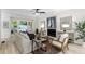 Cozy living room with a fireplace, comfortable seating, and large windows offering views of the backyard at 5560 Pilgrim Point Ext, Cumming, GA 30041