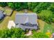 Aerial shot of home showcasing the roof, driveway, walkway, and lush green landscaping at 5960 Bridge Stone Ct, Cumming, GA 30028
