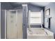 Primary bath featuring a soaking tub and walk in shower at 5960 Bridge Stone Ct, Cumming, GA 30028