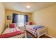 Bedroom features two twin beds with colorful striped bedding and wood floors at 5960 Bridge Stone Ct, Cumming, GA 30028